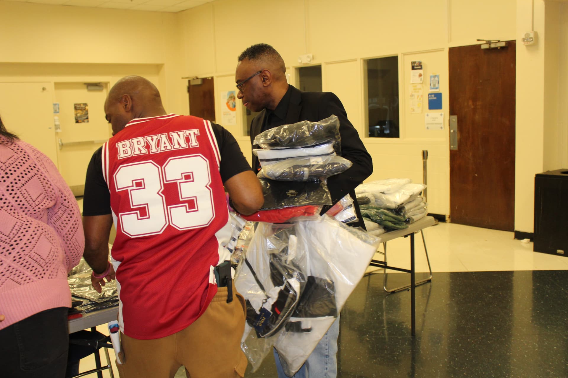Volunteers handing out professional clothing to attendees
